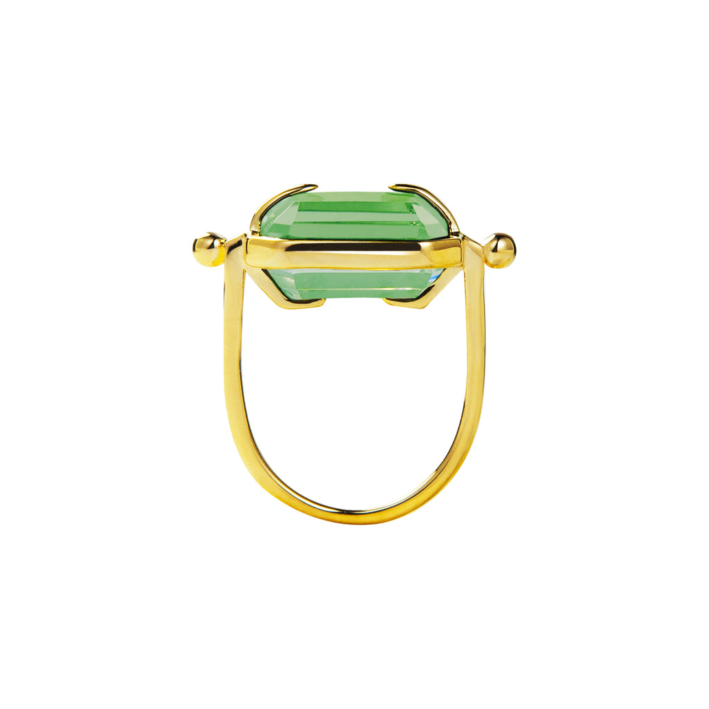 Ring with a light green crystal